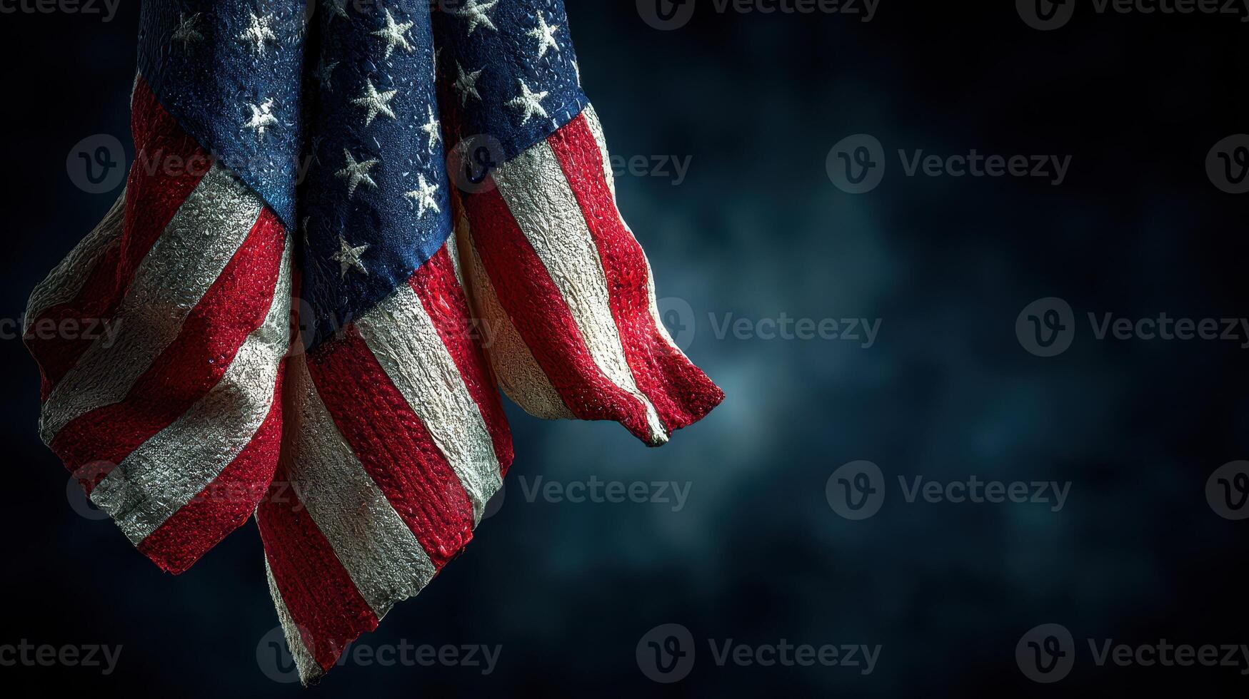 Waving American flag draped elegantly against a dark backdrop highlighting patriotism and national pride photo