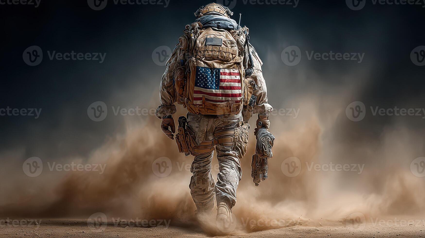 Soldier walks through dusty terrain while carrying equipment in a military operation photo