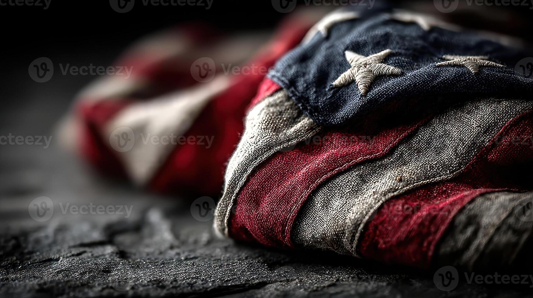 Worn American flag draped on textured surface evokes patriotic symbolism and historical significance photo