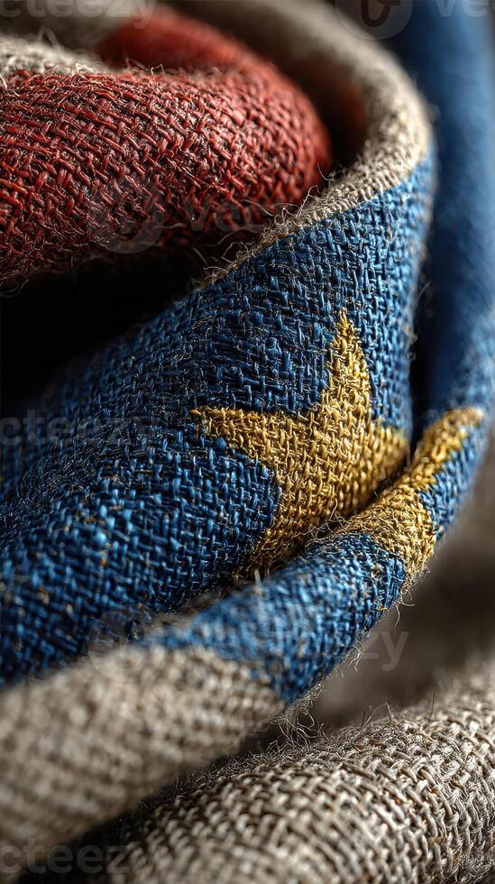 Woven fabric depicting a colorful star pattern in red, blue, and yellow with intricate textile details captured in natural light photo