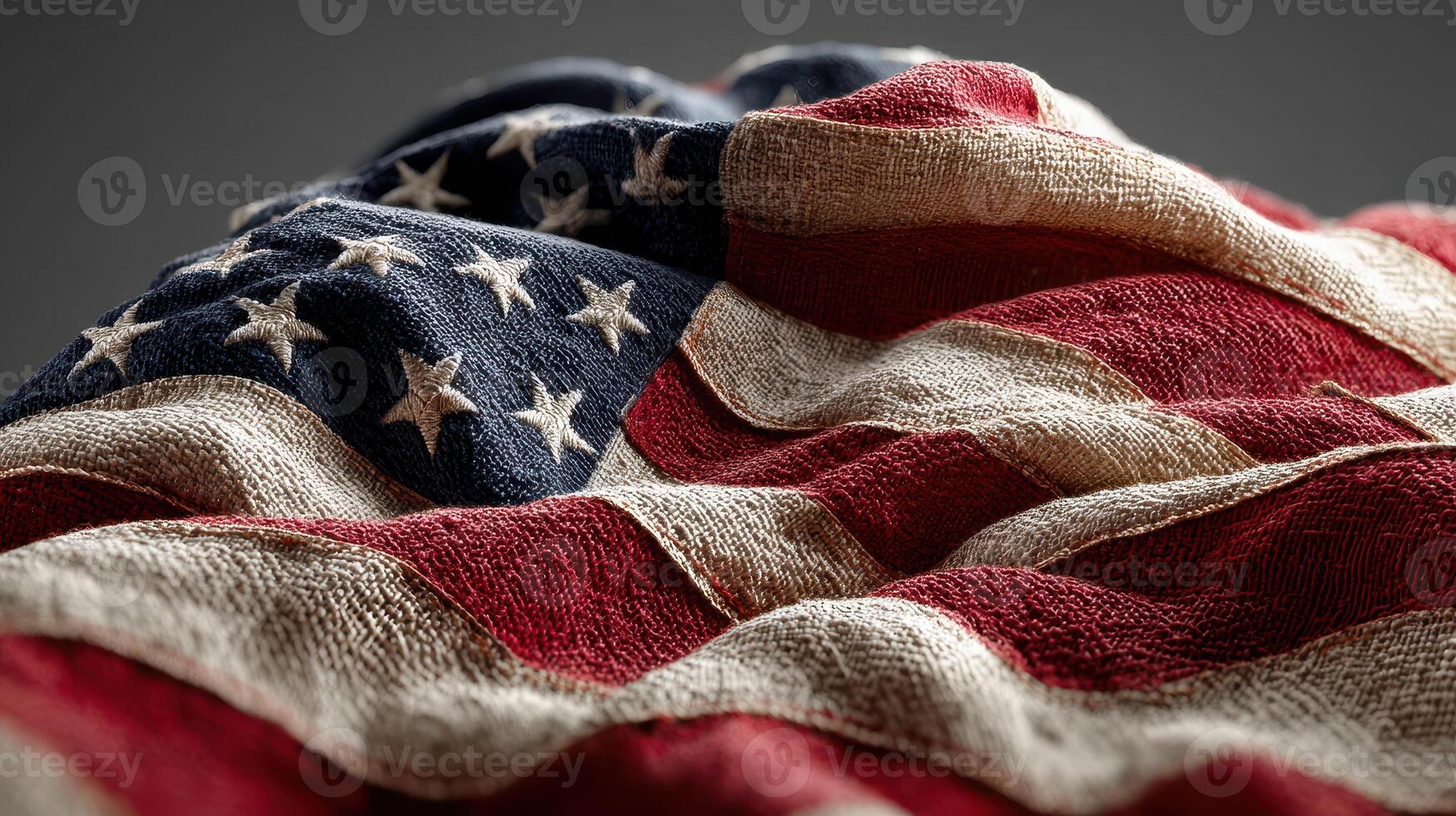 Waving American flag draped over textured surface in soft light captures national pride and spirit photo