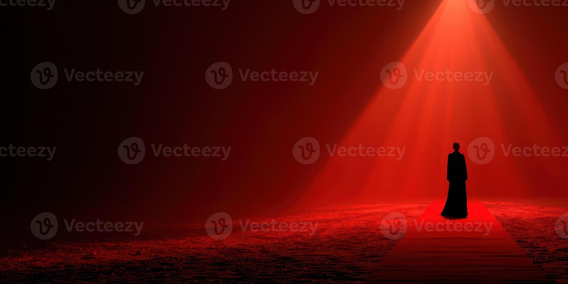 Mysterious figure stands on a red carpet illuminated by a spotlight in a dim, atmospheric setting photo