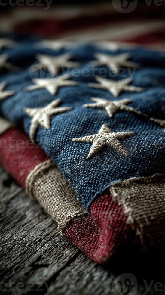 Close-up of a folded American flag showcasing intricate stitching on a rustic wooden surface photo