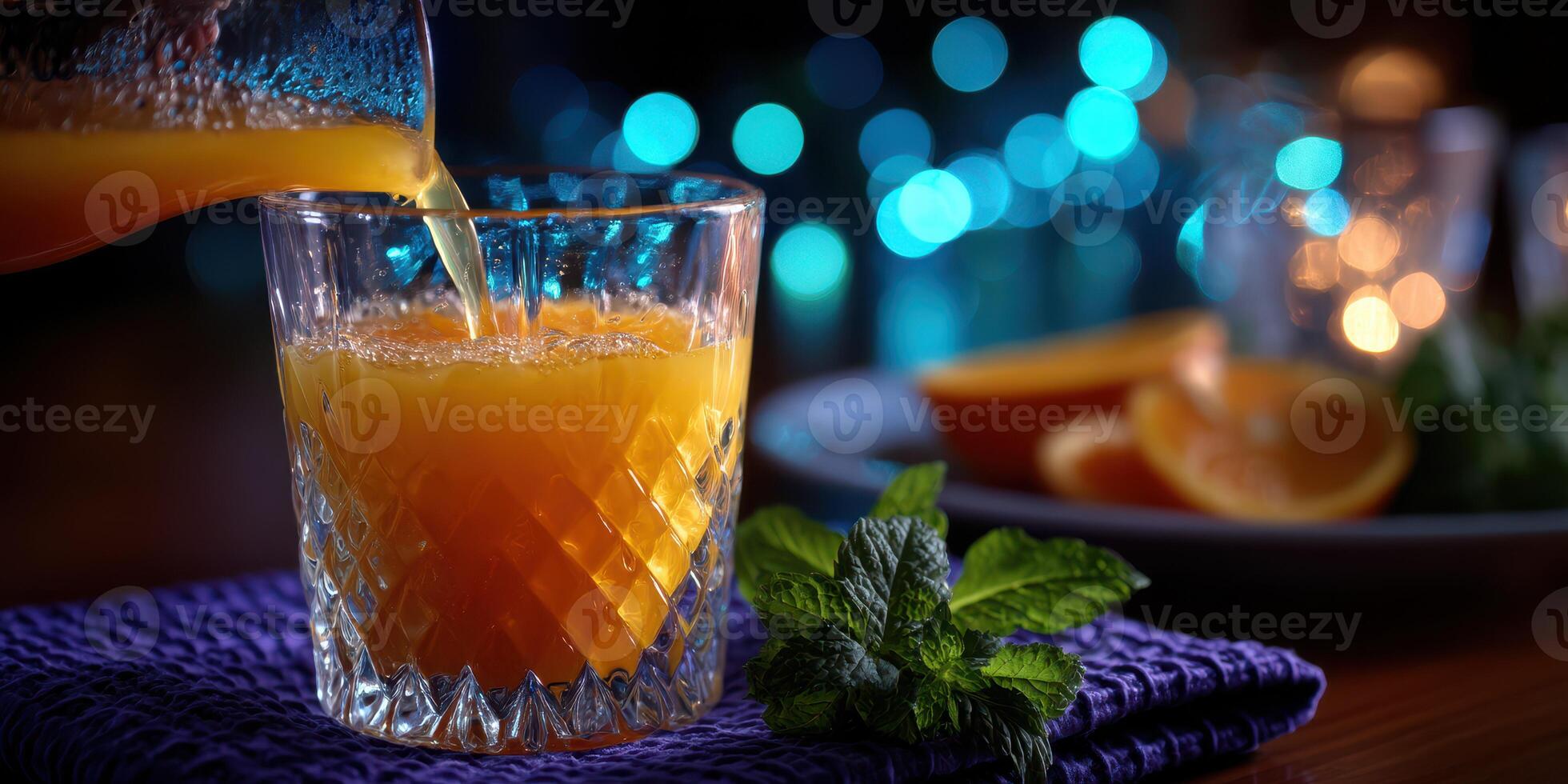 Refreshment served in a crystal tumbler with glowing background at an evening gathering photo