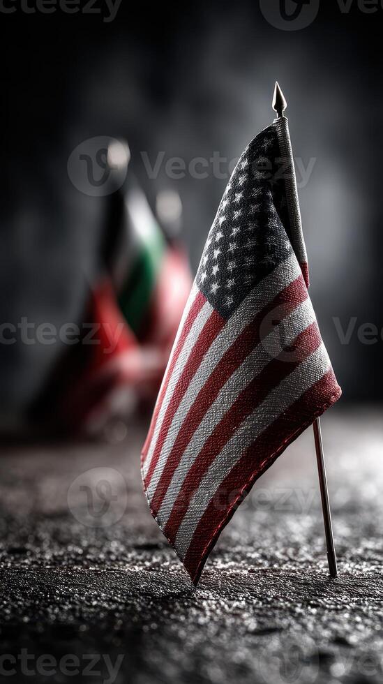 Flag displayed prominently on a textured surface with soft background lighting highlighting additional flags photo