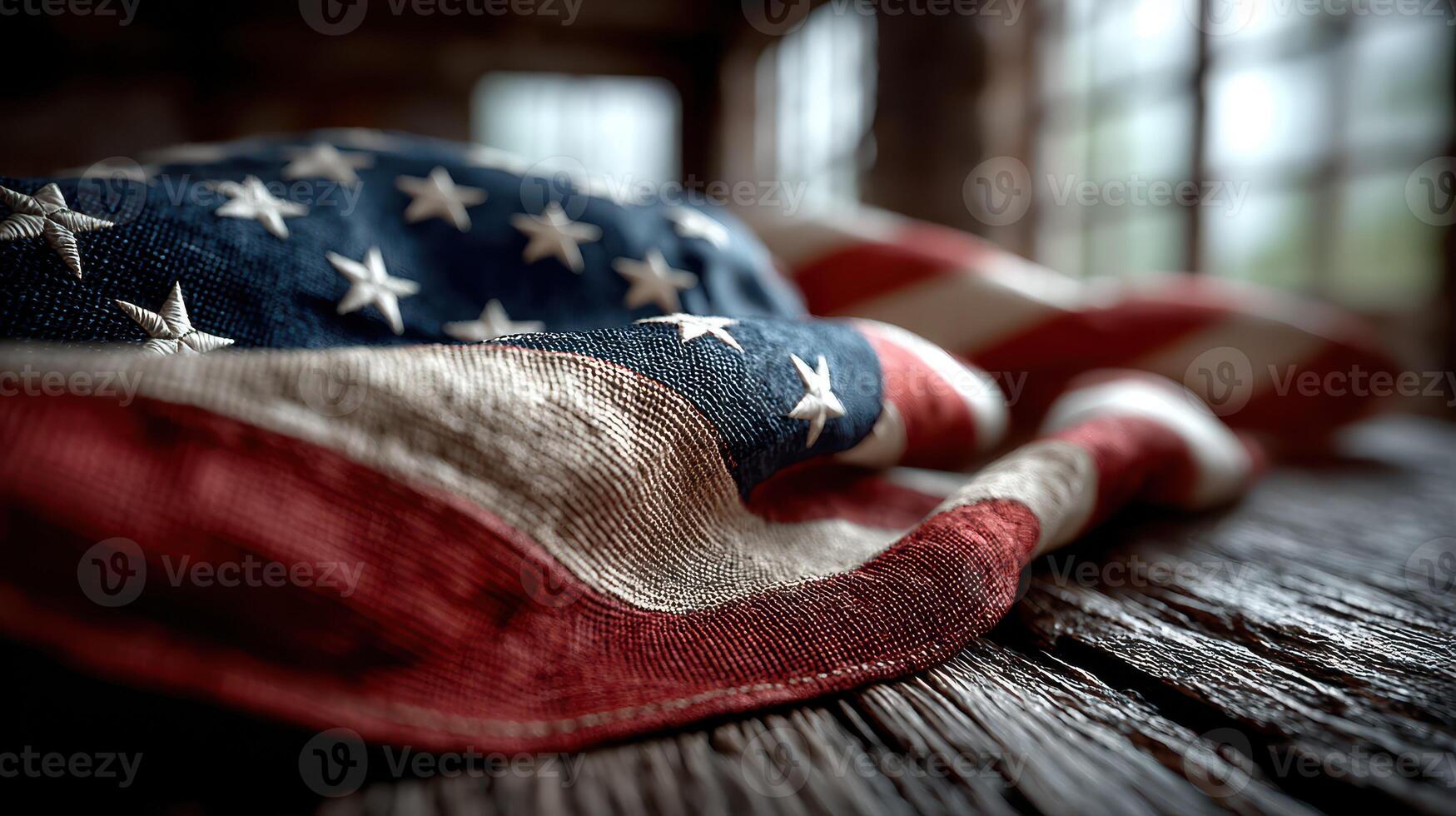 Close-up view of an American flag draped on a weathered wooden surface in a rustic setting photo
