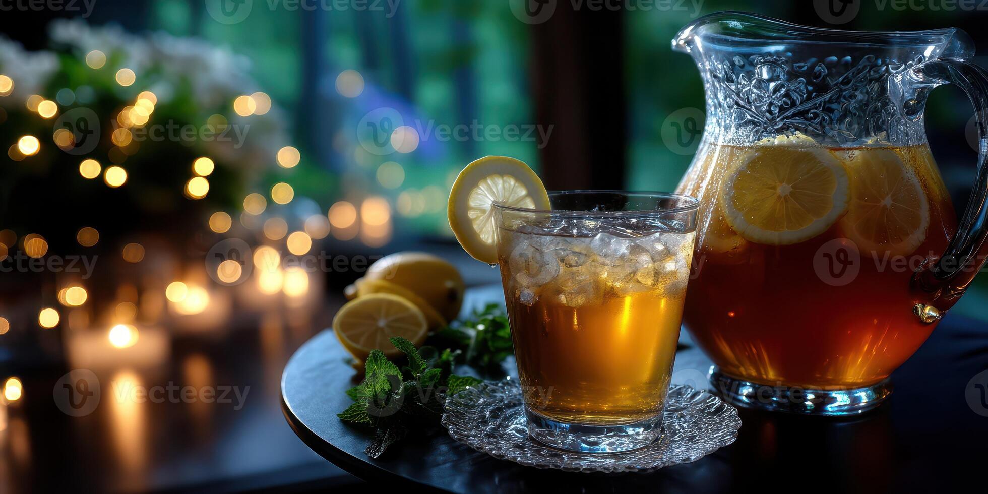 Refreshing iced tea served in a glass with lemon and mint in a cozy evening setting near glowing lights photo