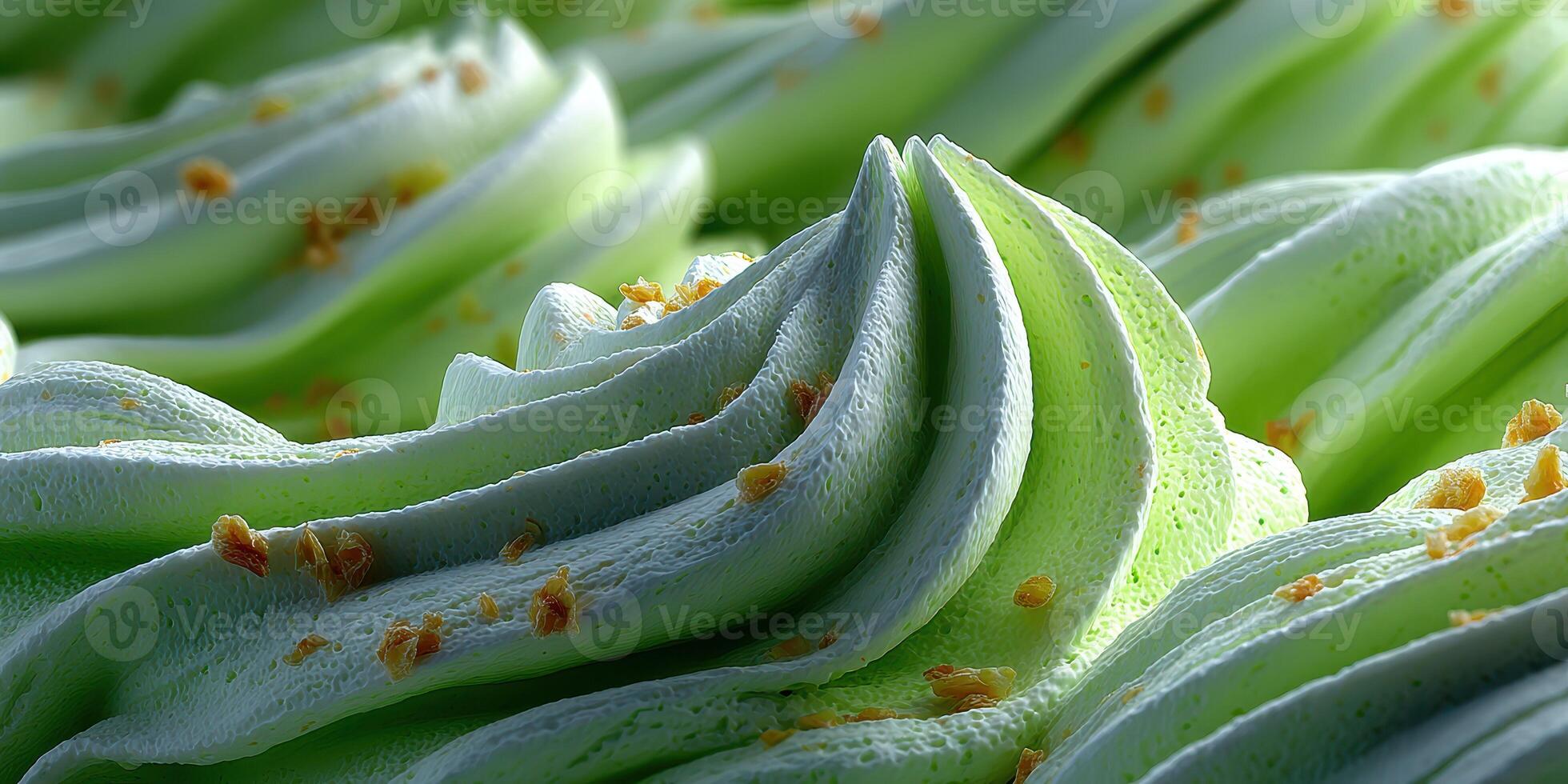 Swirls of light green dessert topping with crumbly bits against a soft texture in a close-up setting photo