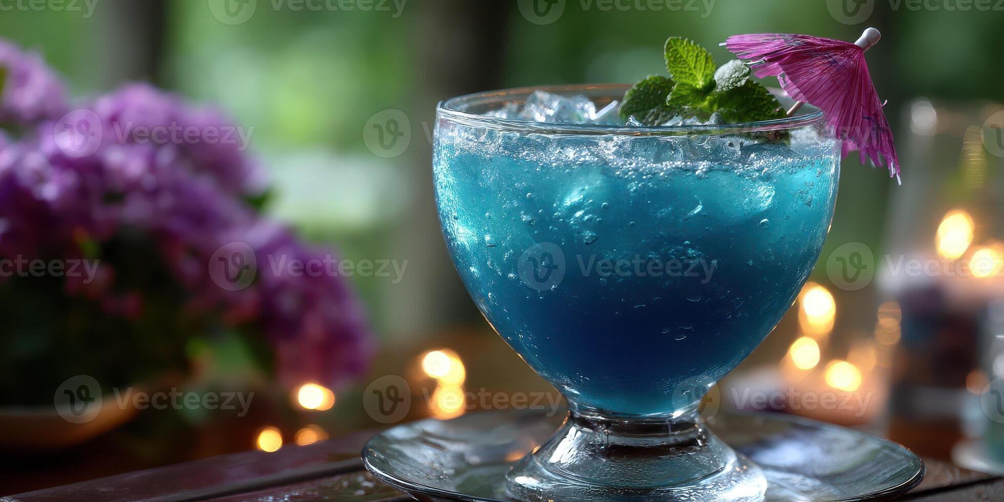 Refreshing tropical blue cocktail served at an outdoor lounge in the evening with floral decorations and soft lighting photo