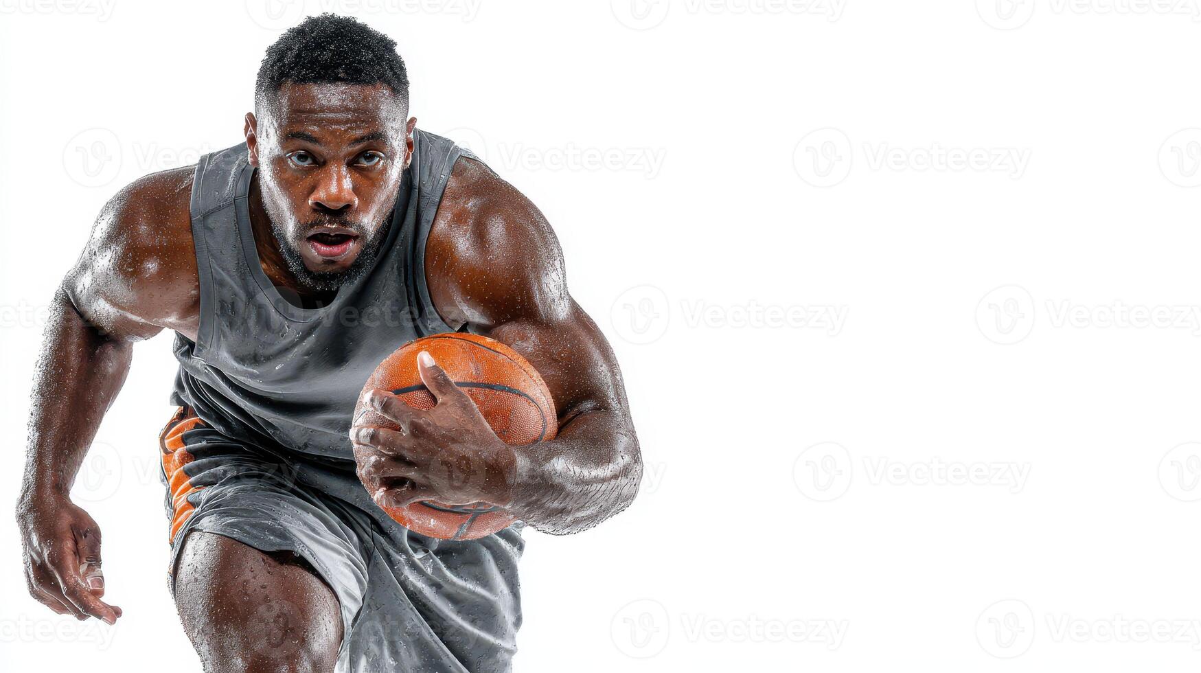 Intense basketball player sprinting towards the hoop in a studio setting during a practice session photo