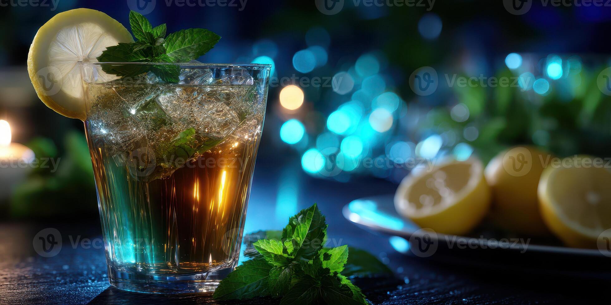 Refreshing mint tea served in a glass with lemon slice and ice complemented by fresh mint leaves photo