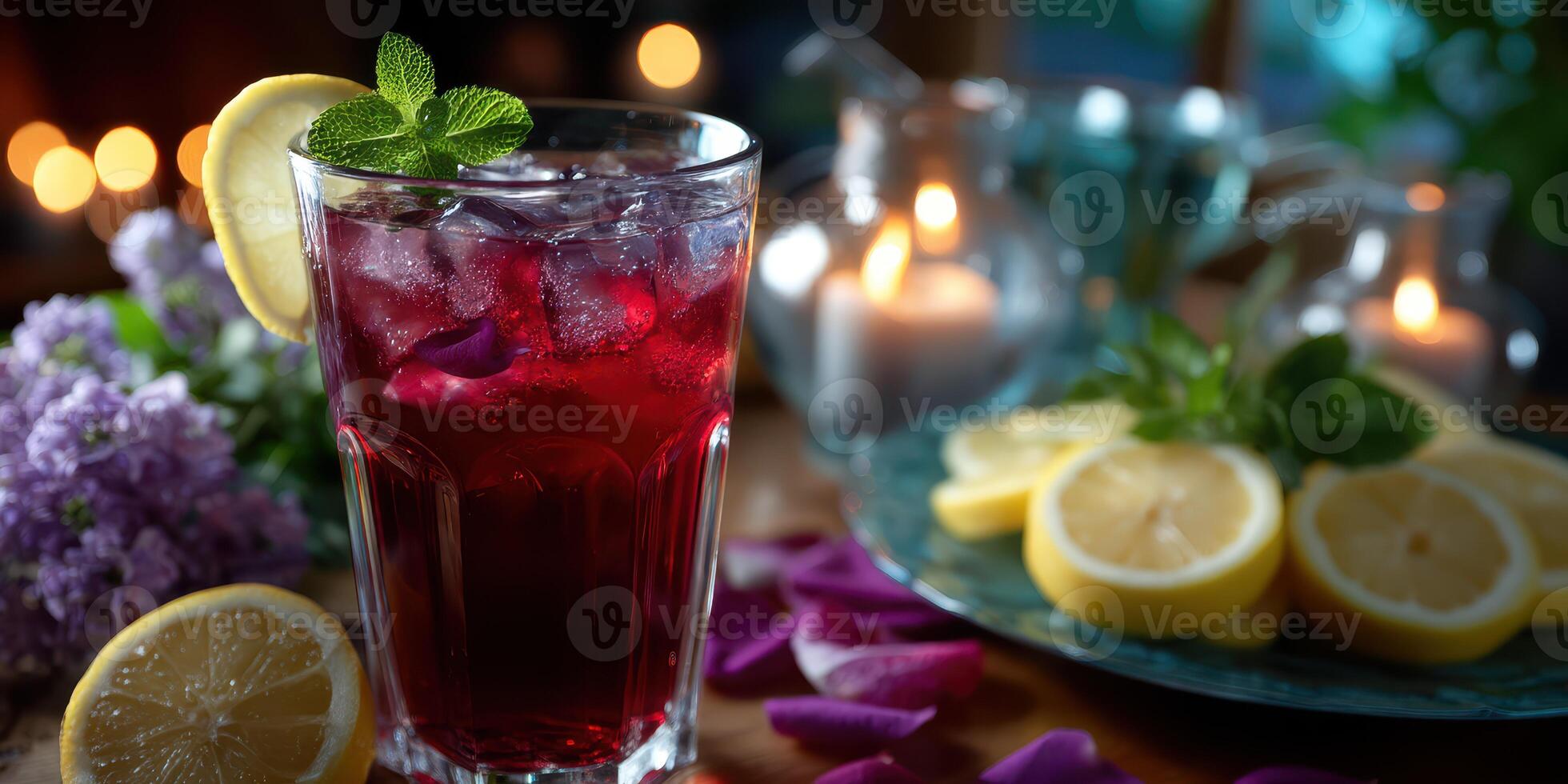 Refreshing summer drink with lemon and mint beside glowing candles in an intimate setting photo