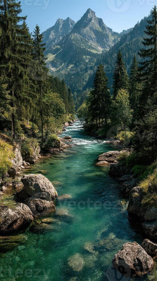 Scenic mountain river flows through lush forest on a clear day with peaks rising in the background photo