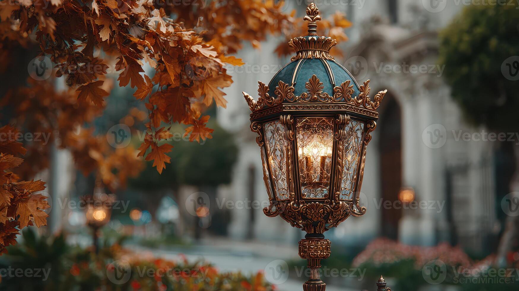 Ornate street lamp illuminates autumn leaves in elegant city square at dusk photo