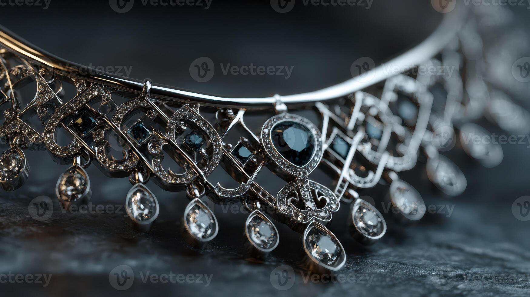 Exquisite silver necklace with intricate design and sparkling gems displayed on a dark stone surface photo