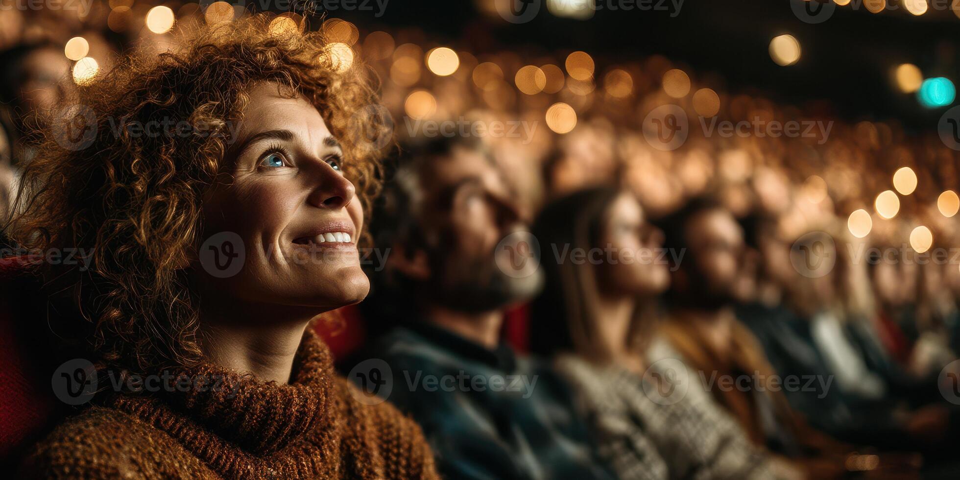 Audience enjoys captivating performance in a theater filled with glowing lights during the evening photo
