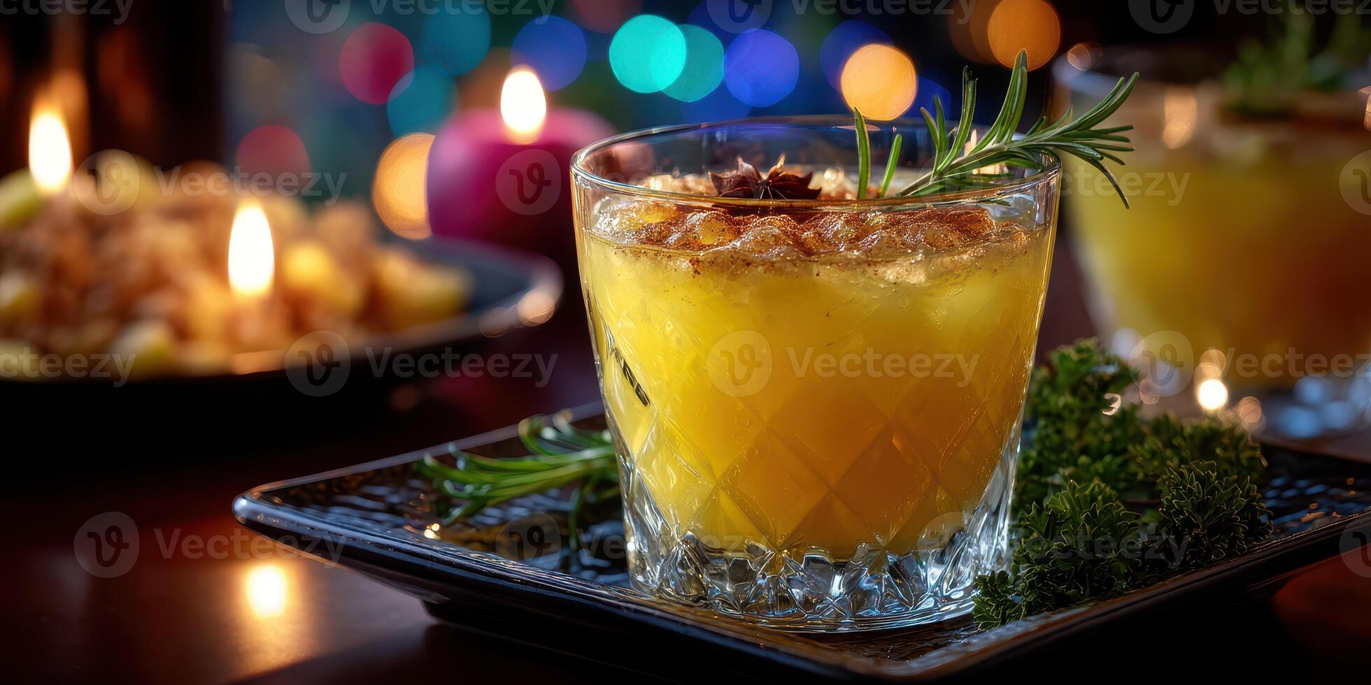 Colorful cocktail with herbs garnishing on a festive table with candles and blurred lights in the background photo
