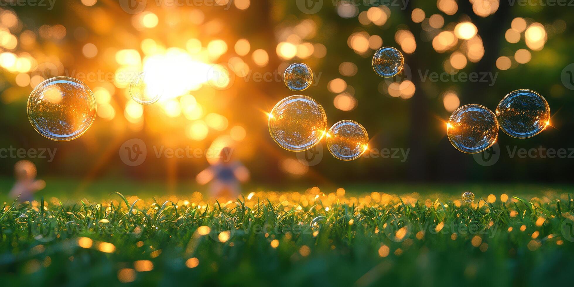 Colorful soap bubbles float in the sunset glow above a grassy field during a serene evening moment photo