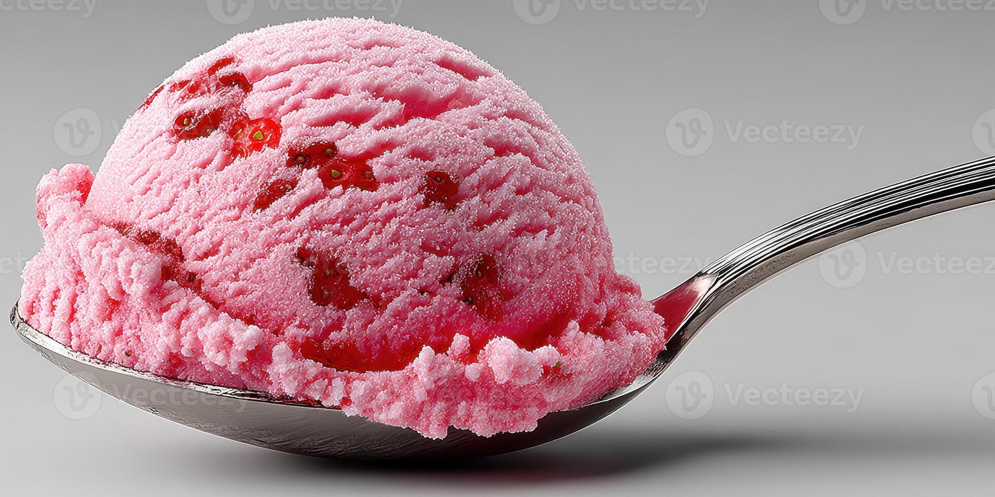 Scoop of strawberry ice cream on a silver spoon with vibrant pink color and berry pieces during a summer treat photo
