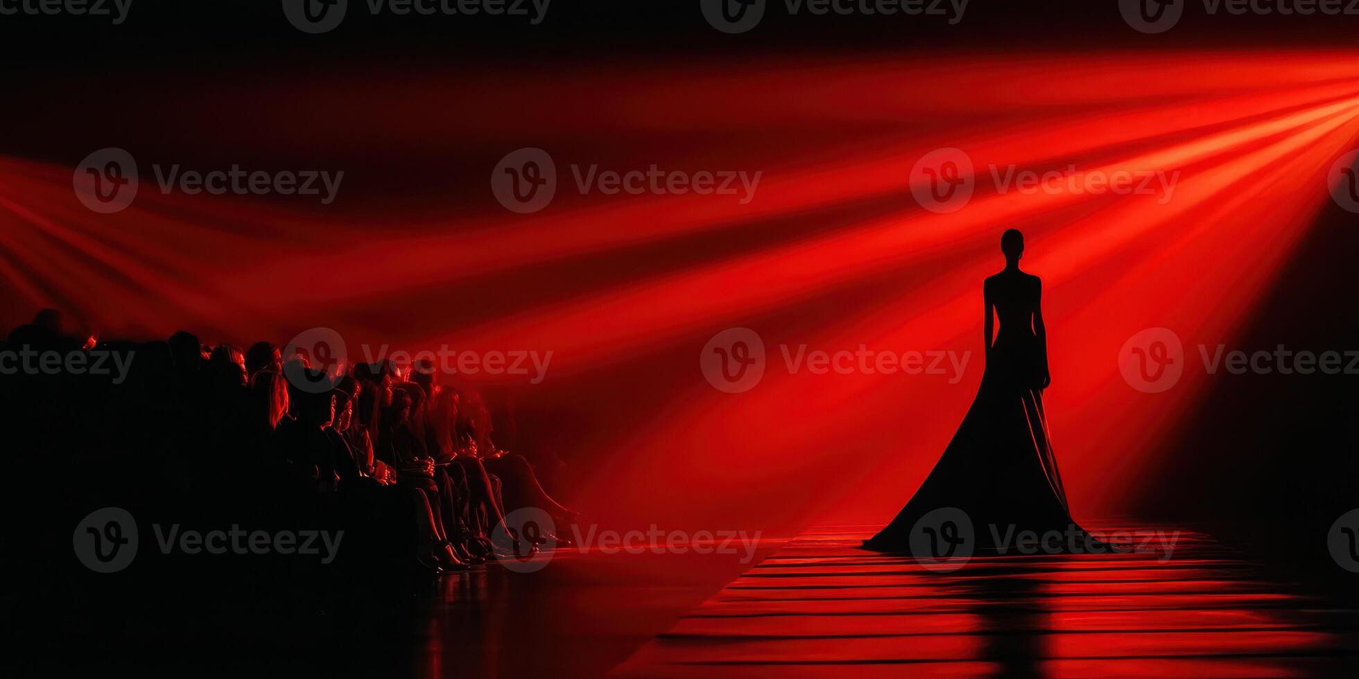 Fashion model walks the runway under dramatic red lighting at a high-profile fashion event in a bustling city photo