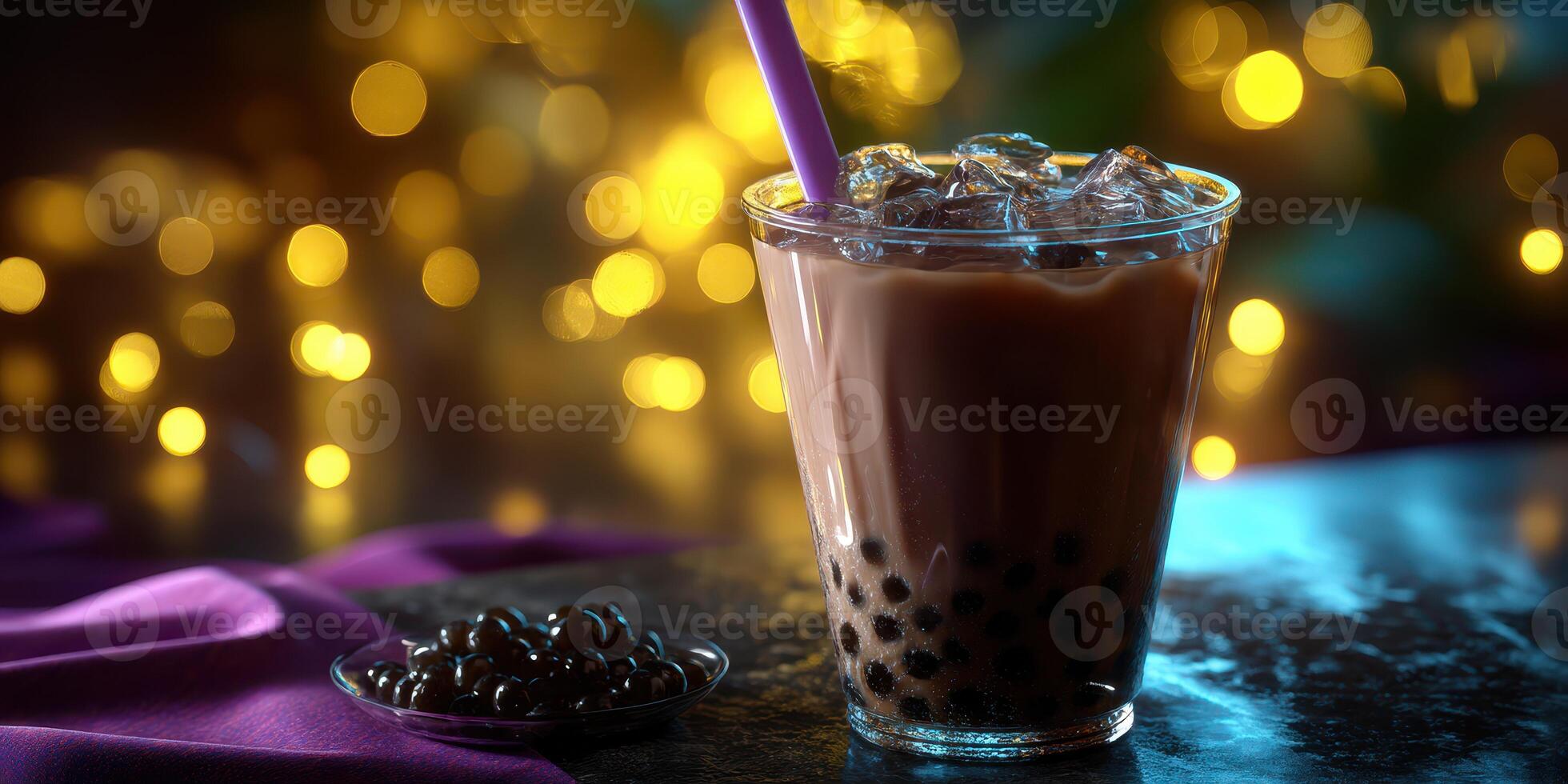 Delicious iced beverage featuring tapioca pearls served in a glass during evening ambiance with glowing lights photo