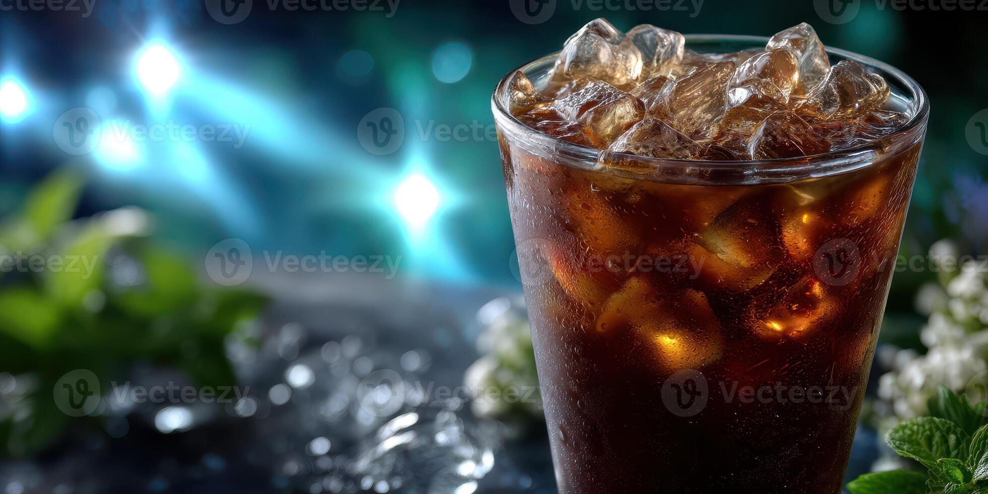 Refreshing glass of iced beverage with mint leaves against a sparkling blue background photo
