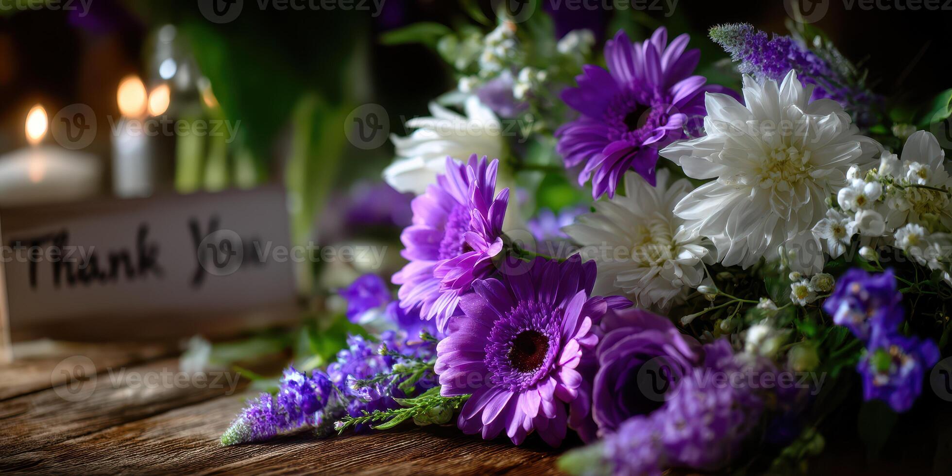 Beautiful assortment of purple and white flowers with a thank you note on a rustic wooden table photo