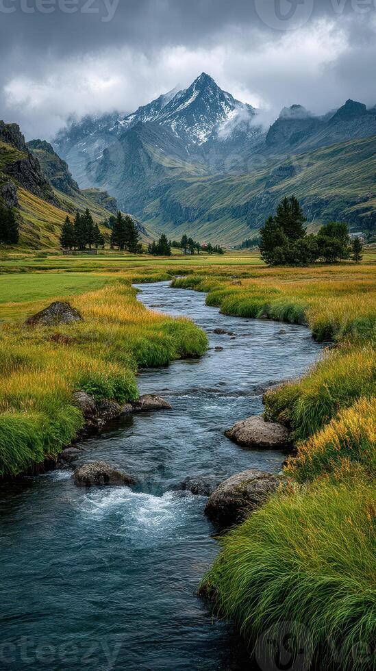 Majestic mountain landscape with flowing river and lush greenery during overcast weather in the afternoon photo