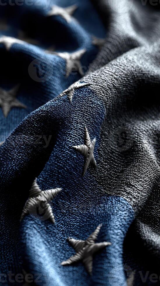 Close-up view of a textured American flag fabric displaying embroidered stars on a dark blue background photo