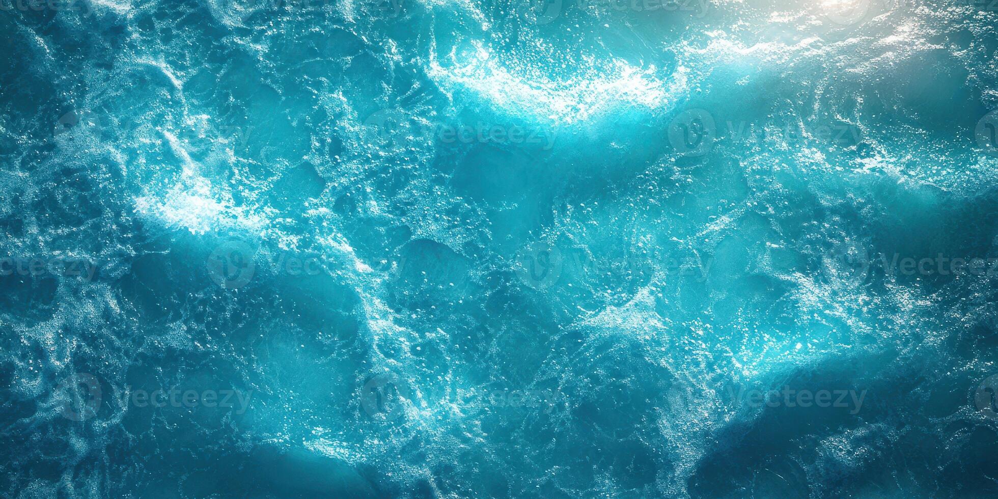 Vibrant ocean waves ripple beneath bright sunlight on a clear day photo