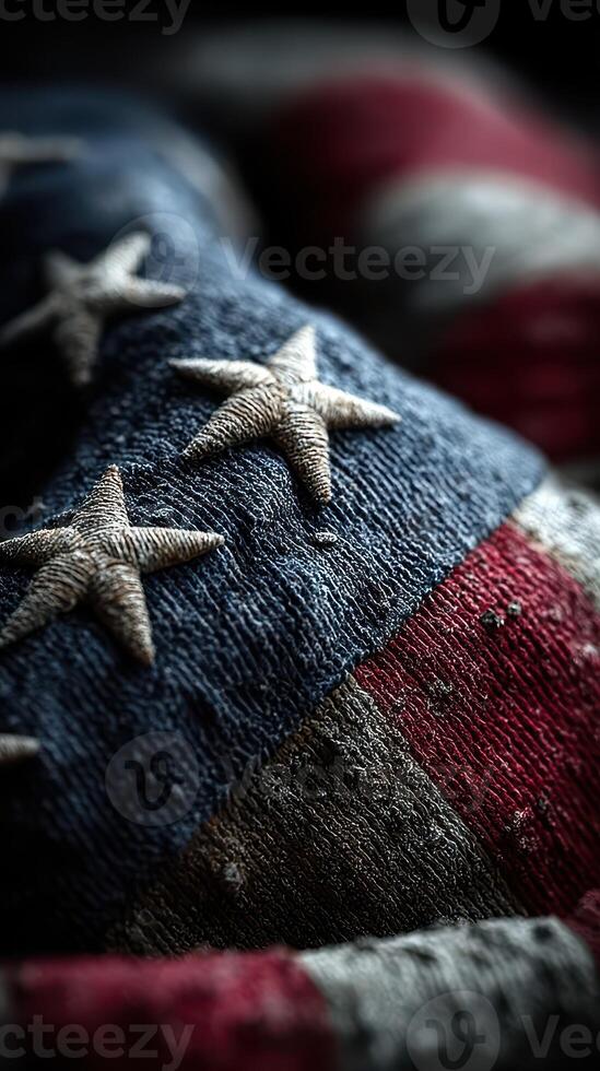 Close-up view of a gently worn American flag showcasing intricate stitching and faded colors photo