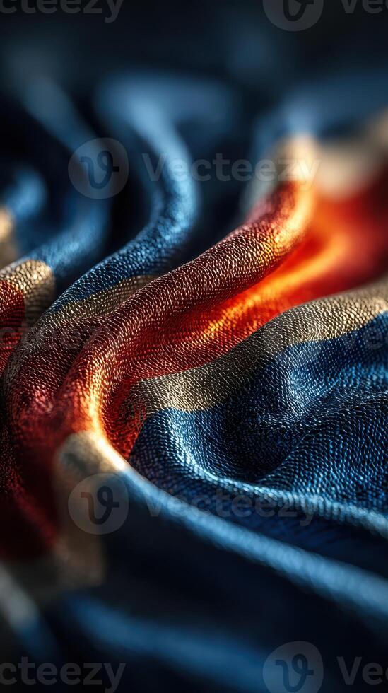 Textile showcasing vibrant blue, orange, and gold hues forming intricate patterns in soft fabric photo