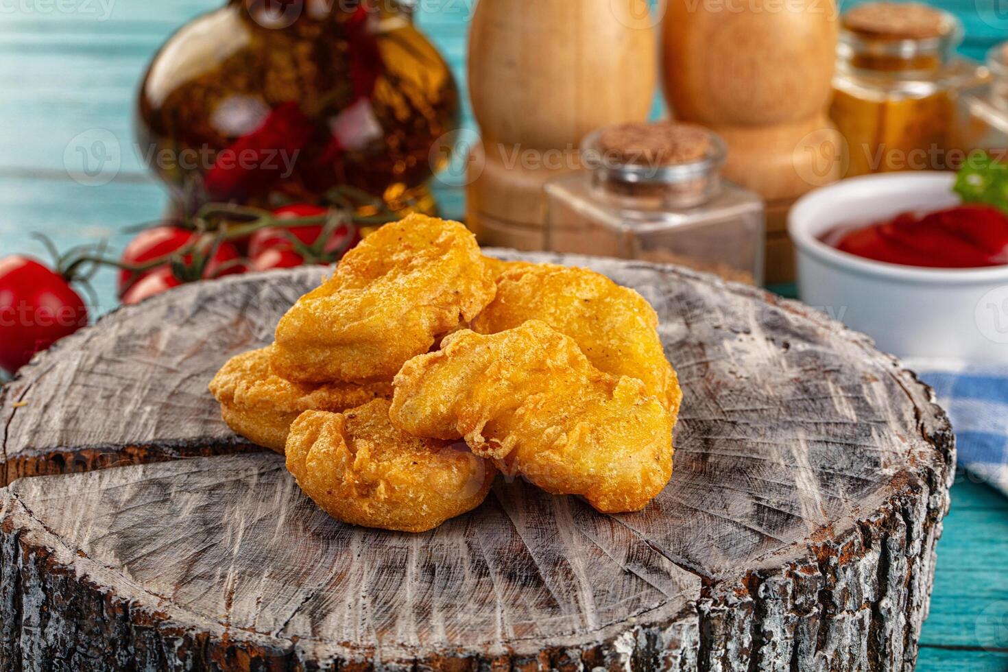A pile of fried chicken on a wooden table photo