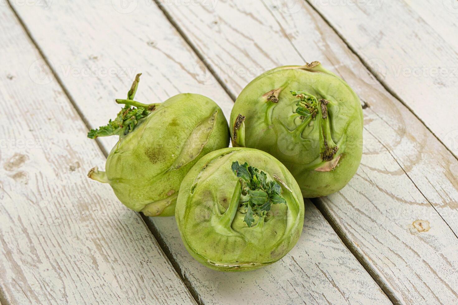 Three green artichokes on a wooden table photo