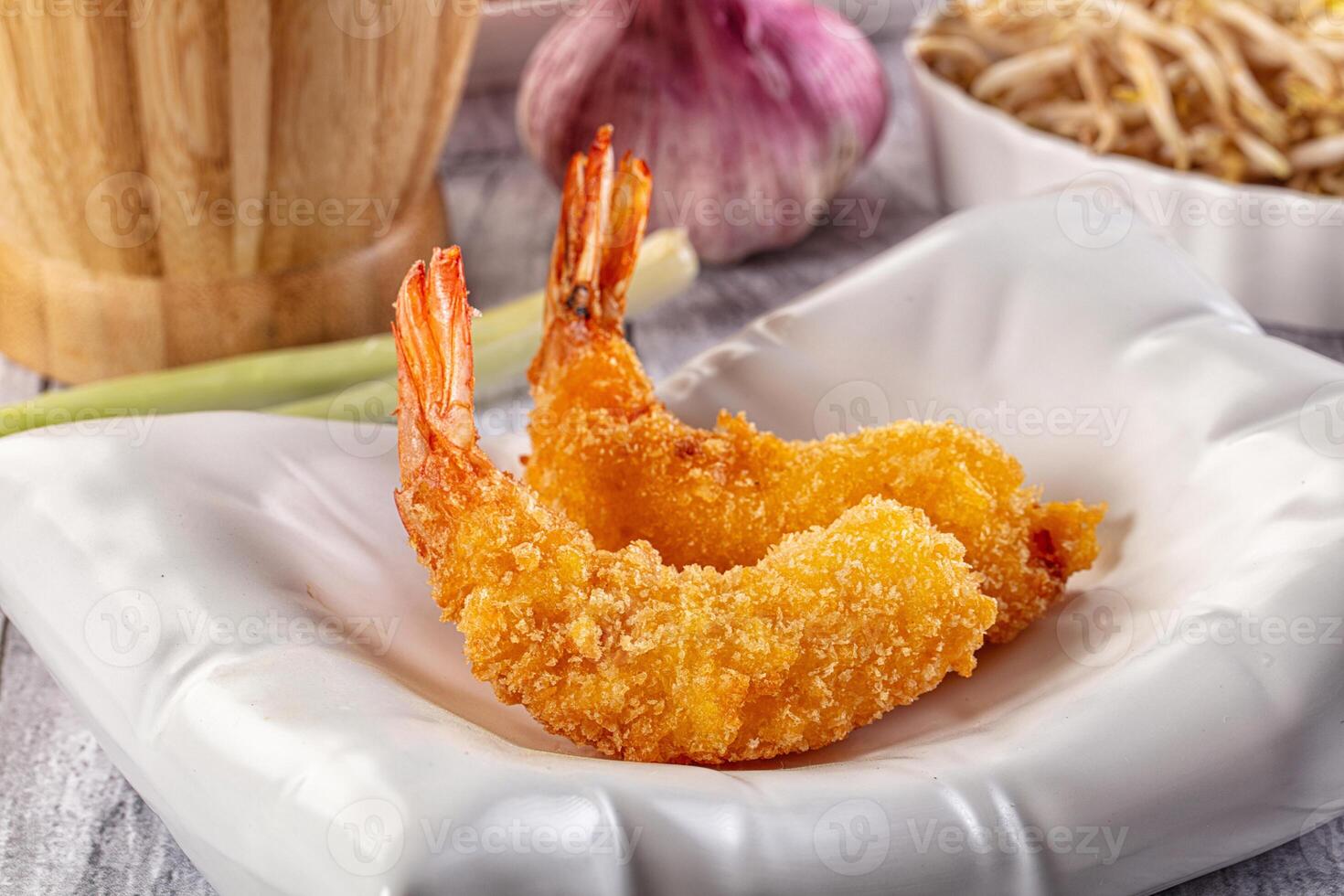 Fried shrimp on a white plate with a bowl of rice photo