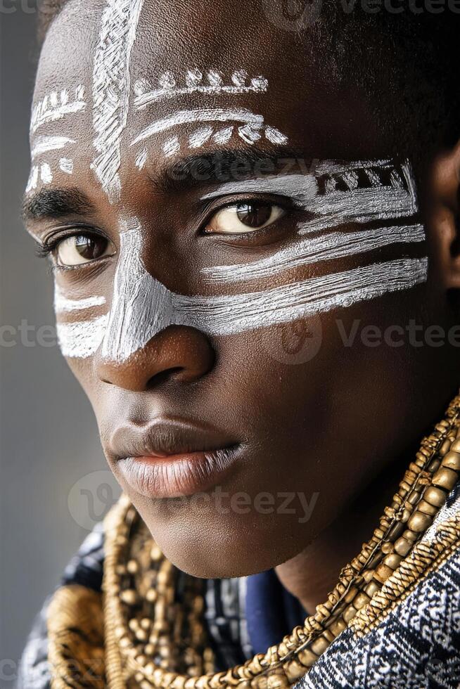 A portrait of an African man with white tribal face paint photo