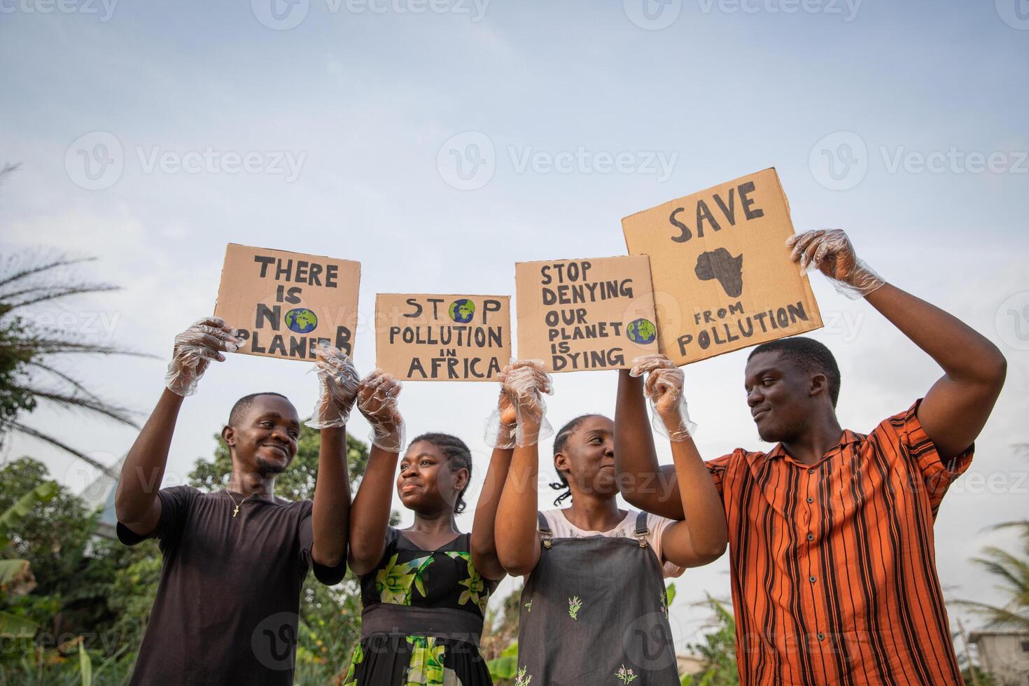Youth holding signs with written there is no planet b, stop pollution in africa photo