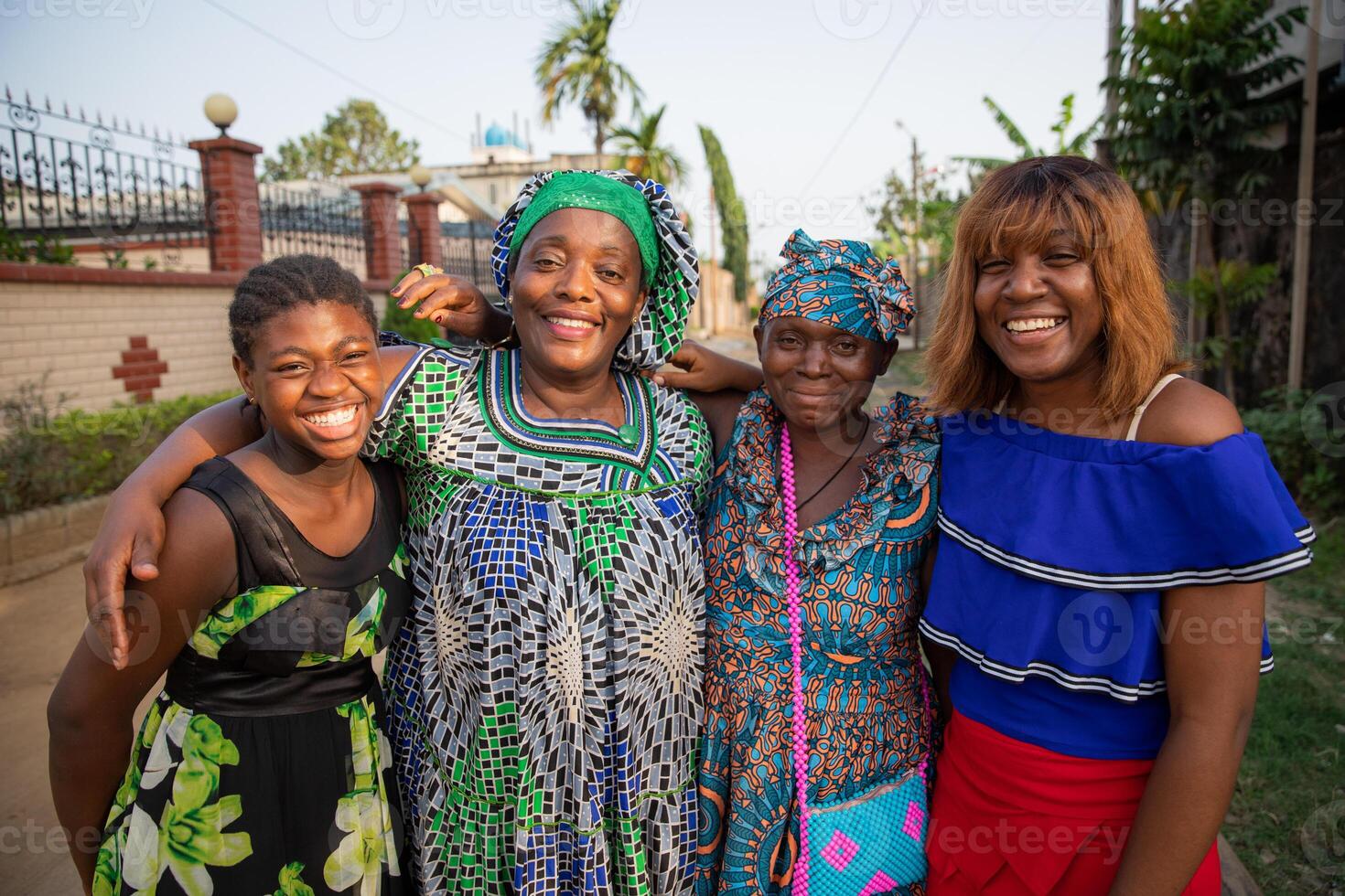 multigenerational group of female african friends together hugging and laughing, African women photo