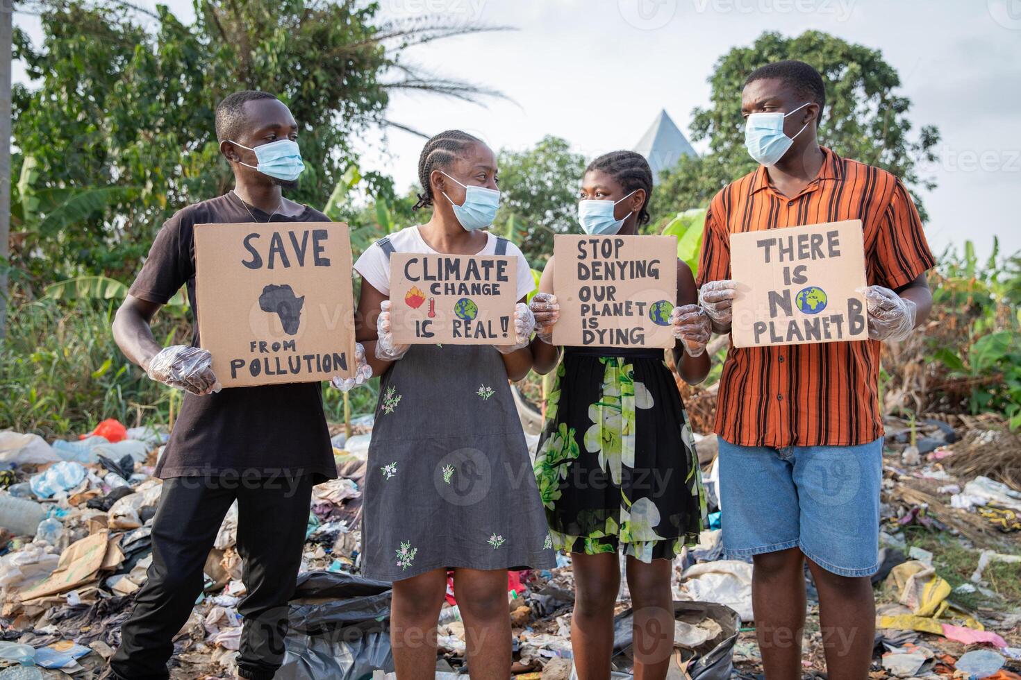 African youth protesting against pollution holding signs written there's no planet b. photo