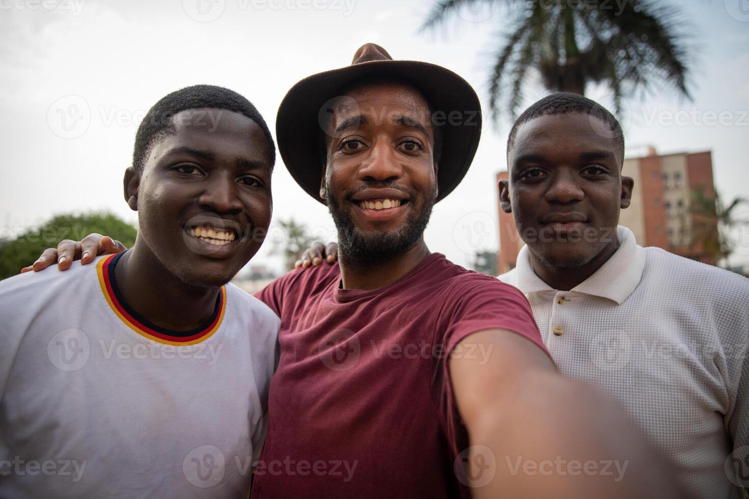 Three young friends take a selfie and are smiling and happy, African guys. photo