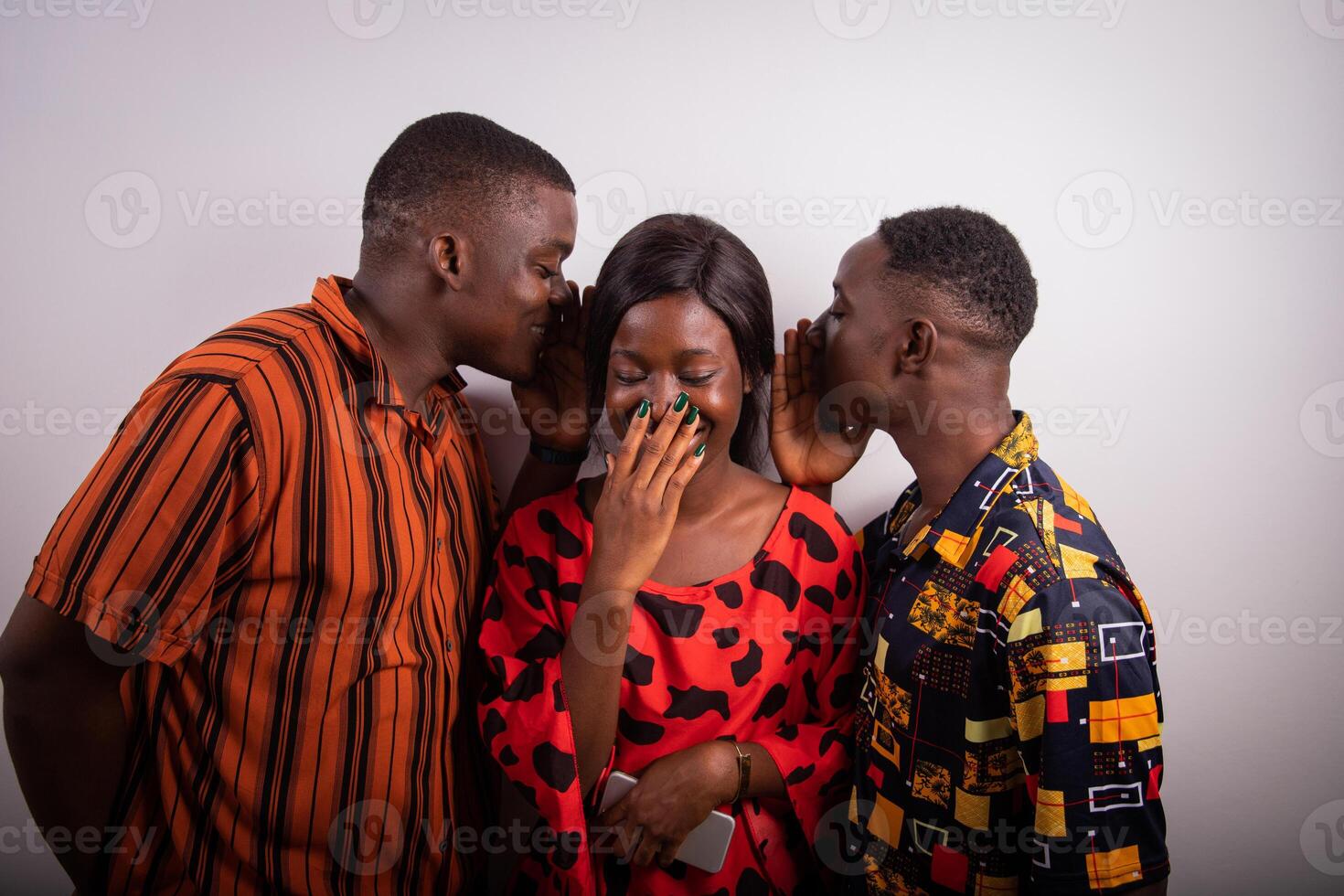 Two guys tell a funny thing to a girl who starts laughing. Friendship concept. photo
