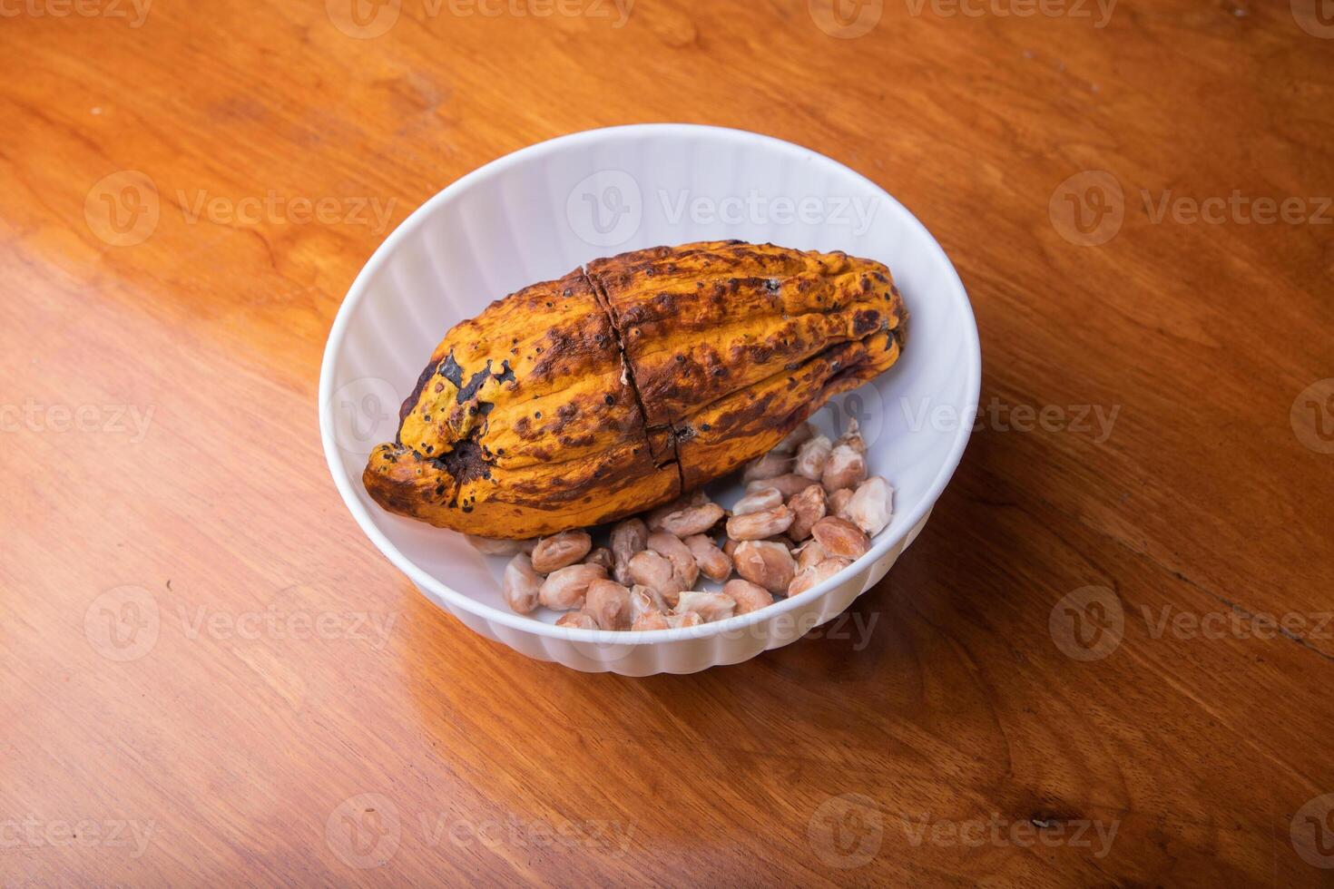 Cocoa pod inside a bowl with the beans removed, processing of the beans to create chocolate. photo