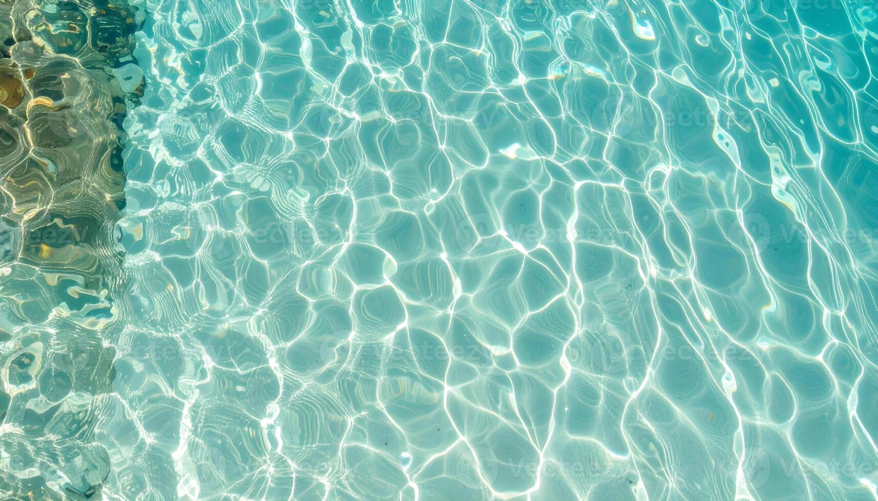 Shimmering turquoise water with delicate ripples and flowing light reflections photo