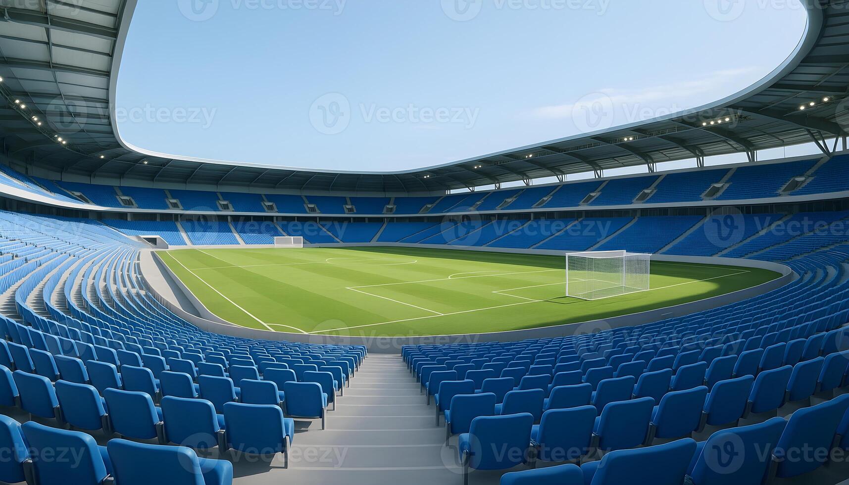 Expansive empty football stadium under clear blue sky with bright sunlight and vibrant green field photo