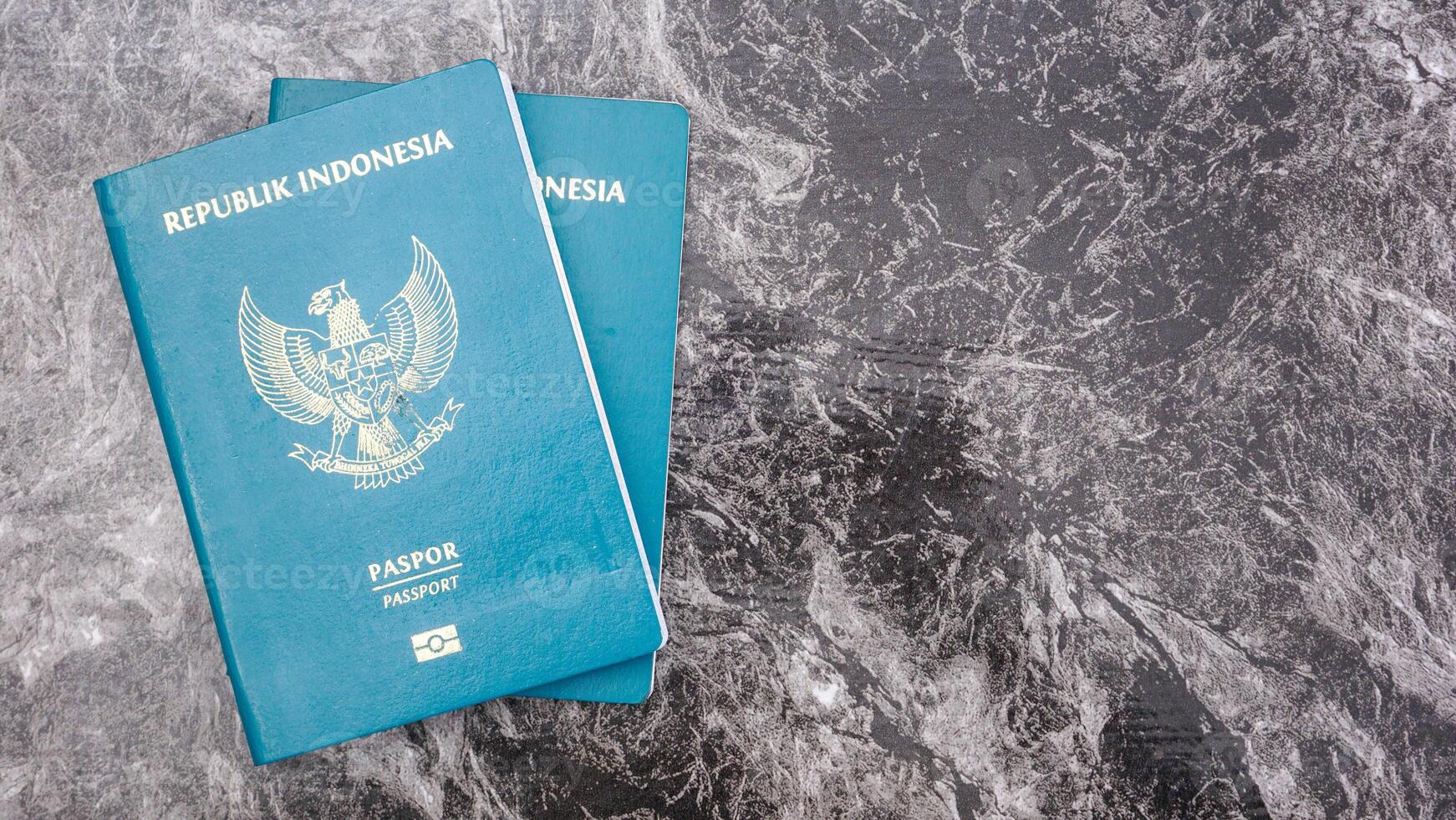 Yogyakarta, Indonesia, 2025 - Indonesian passport documents isolated on marble pattern background photo