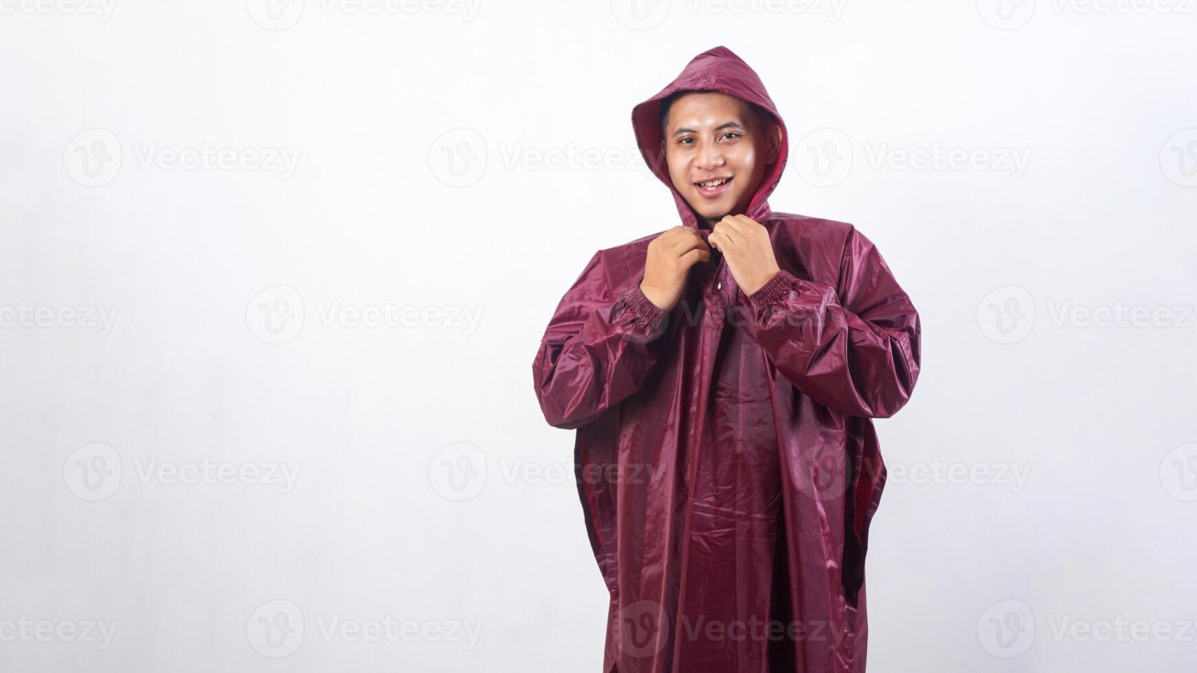 Smiling Asian man in red raincoat isolated on white background photo