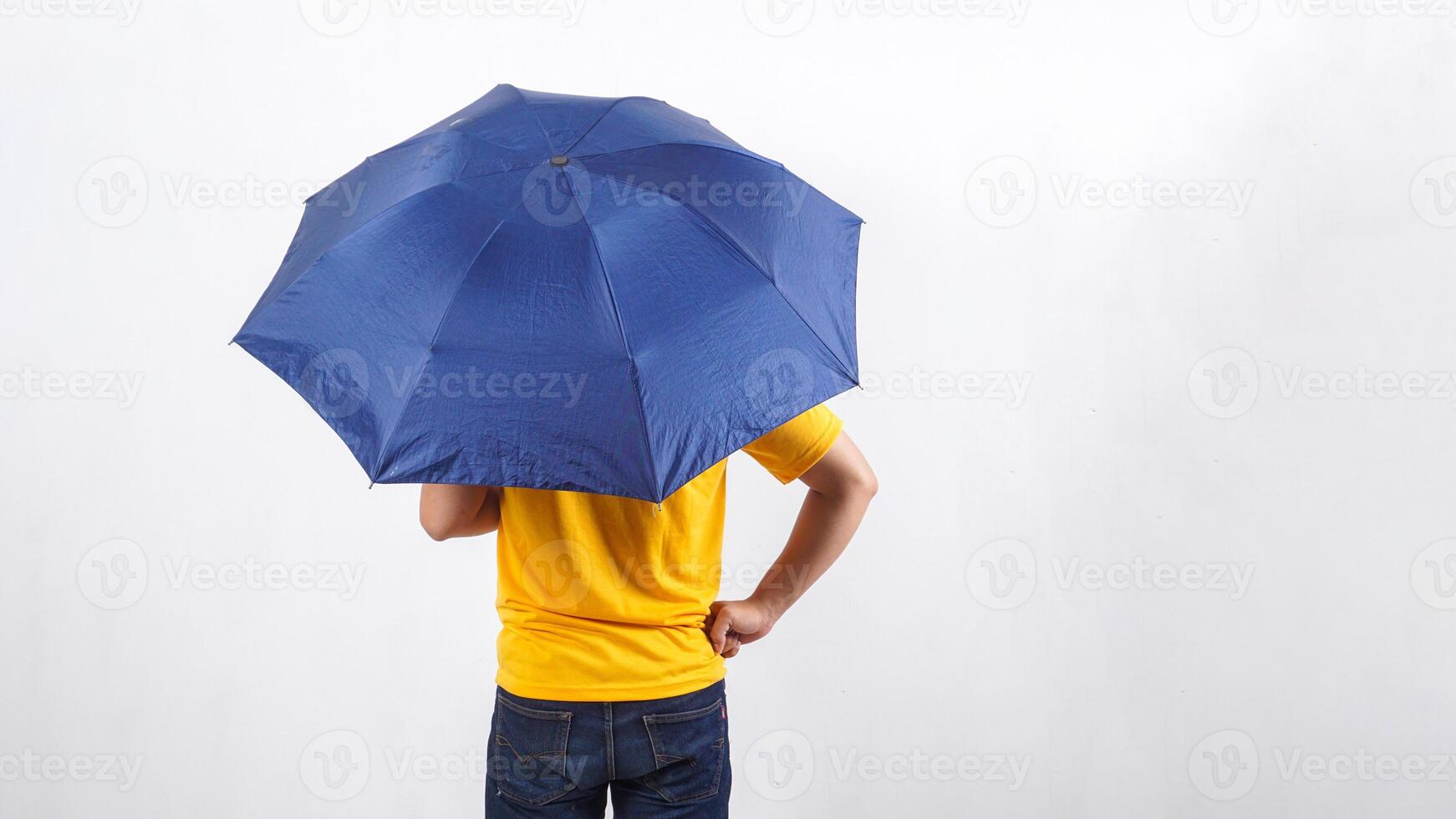 Rear view of man under umbrella isolated on white background photo