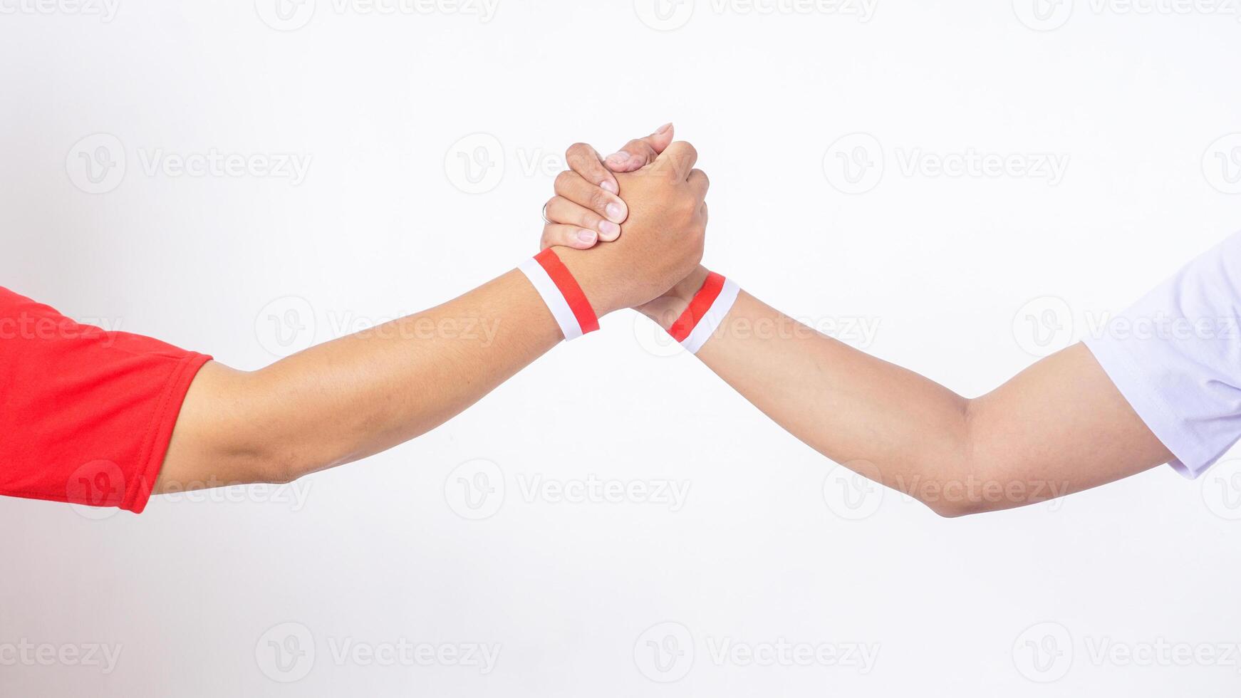 Two men hands with red and white wristband doing unity handshake isolated on white background photo