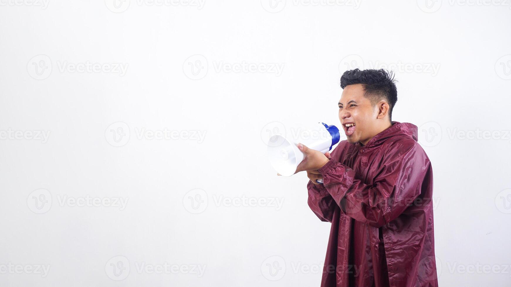 Asian man in red raincoat shout using megaphone isolated on white background photo
