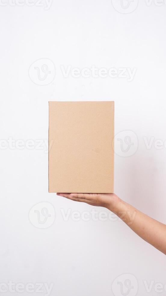 Close up of hand with package box parcel isolated on white background photo